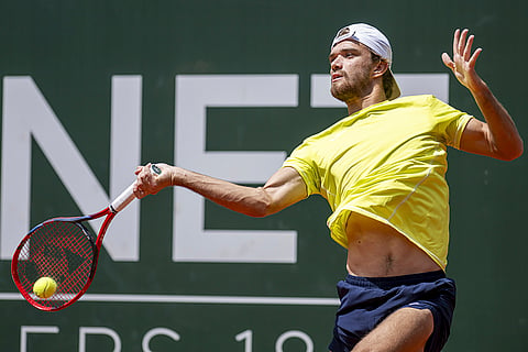 Tomas Machac returns to Novak Djokovic